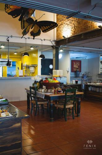 a kitchen with a table with butterflies on the ceiling at Hotel Fenix in Guadalajara