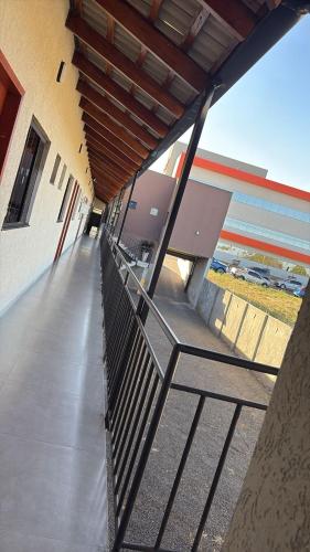 an empty hallway of a building with a metal railing at Belke Hotel in Mineiros