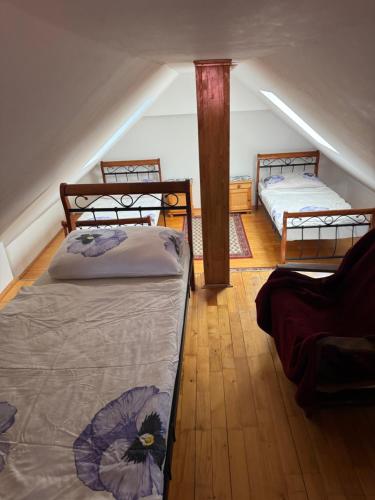 a attic room with two beds in a attic at Privat vila 303 in Martin