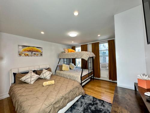 a bedroom with two beds and a bunk bed at BP STAYS - Hotel-Style, No Host, Professionally Managed ID260 in Jersey City