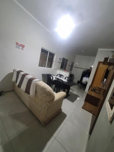 a living room with a couch and a table at Casa Sophia 17 ( Condomínio Aberto ) in Três Lagoas