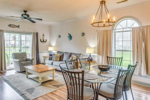 a living room with a table and chairs and a couch at Dog-Friendly Condo with Pool and Golf in Myrtle Beach! in Myrtle Beach