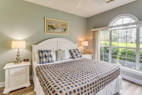 a bedroom with a bed and a large window at Dog-Friendly Condo with Pool and Golf in Myrtle Beach! in Myrtle Beach