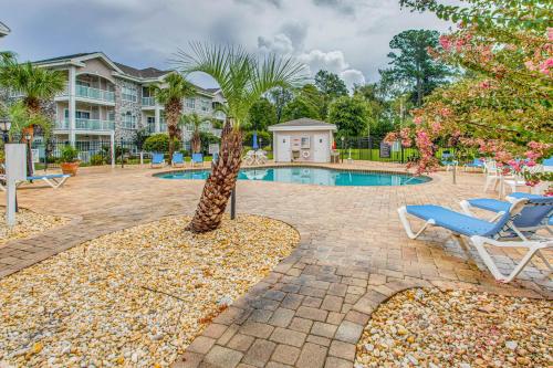 a resort with a pool and a palm tree and chairs at Dog-Friendly Condo with Pool and Golf in Myrtle Beach! in Myrtle Beach