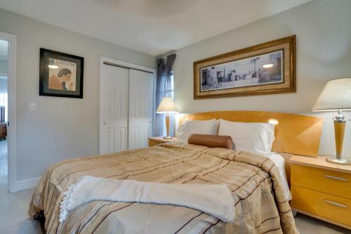 a bedroom with a large bed and two lamps at Walk to Redington Beach Renovated Duplex with Patio in St Pete Beach