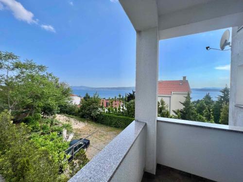 a balcony with a view of the ocean from a building at Apartments in Dramalj 42437 in Dramalj
