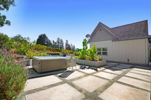 a patio with a hot tub next to a house at Stylish Vineyard Living at Winemakers Estate in Windsor