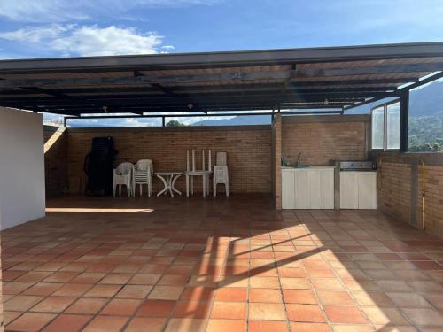 a large patio with a table and chairs on it at Encanto Del Parque in Moniquirá