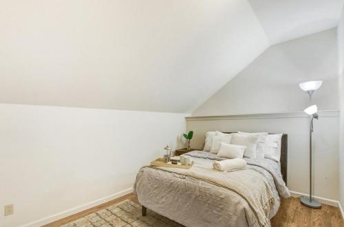 a bedroom with a large bed with white walls at Stylish Vineyard Living at Winemakers Estate in Windsor