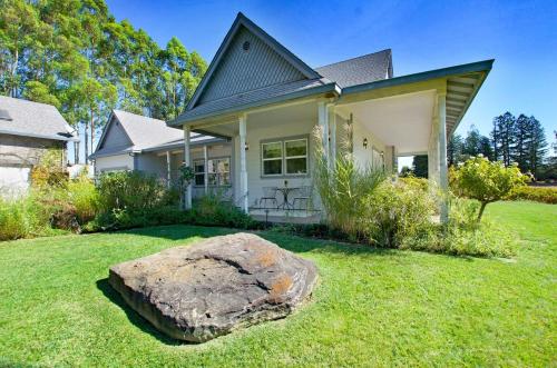 a house with a large rock in the yard at Stylish Vineyard Living at Winemakers Estate in Windsor