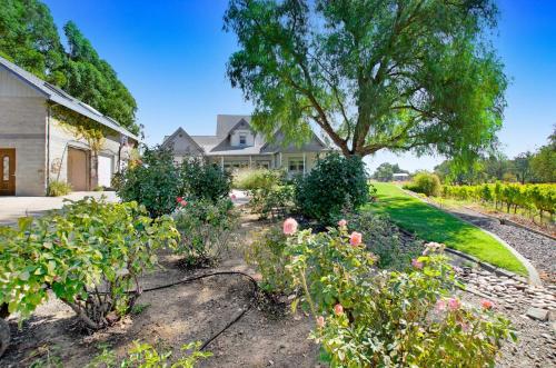 a garden in front of a house with a tree at Stylish Vineyard Living at Winemakers Estate in Windsor