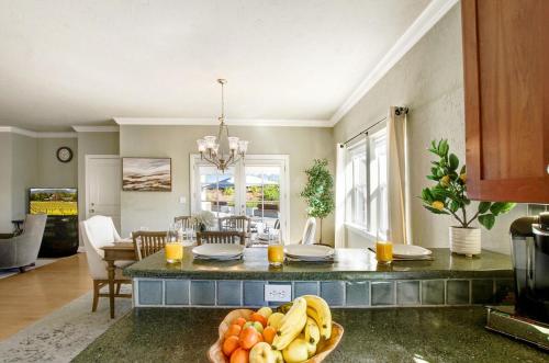 a kitchen with a table with a bowl of fruit at Stylish Vineyard Living at Winemakers Estate in Windsor