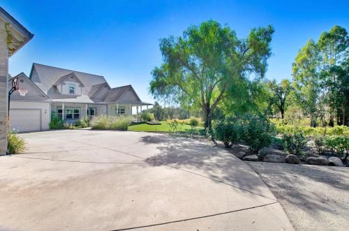 a large house with a driveway at Stylish Vineyard Living at Winemakers Estate in Windsor