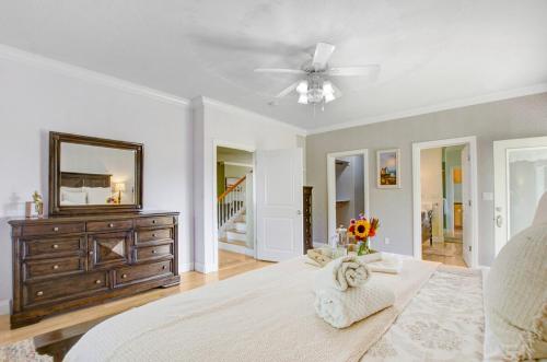 a bedroom with a bed with a dresser and a mirror at Stylish Vineyard Living at Winemakers Estate in Windsor