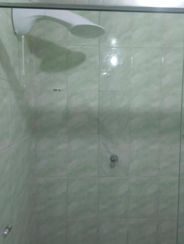 a shower with a glass door in a bathroom at Casa Vila Becker in Campos do Jordão