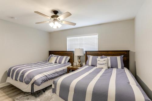 a bedroom with two beds and a ceiling fan at Private Boat Slip Boaters Haven in Greers Ferry! in Greers Ferry