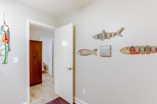 a hallway with a door with surfboards on the wall at Private Boat Slip Boaters Haven in Greers Ferry! in Greers Ferry