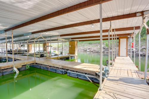 a house with a pool of green water at Private Boat Slip Boaters Haven in Greers Ferry! in Greers Ferry