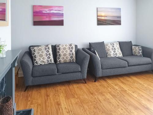 a living room with two chairs and a couch at Turtle's Nest in Newbiggin-by-the-Sea