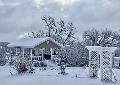 a gazebo in a yard covered in snow at The Lookout House at The Bluebird in Eureka Springs