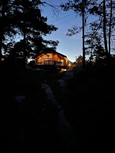 a house lit up at night in the woods at Sunny Side in Hvaler