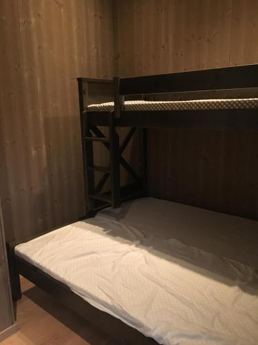 a bunk bed in a room with a white mattress at Sunny Side in Hvaler