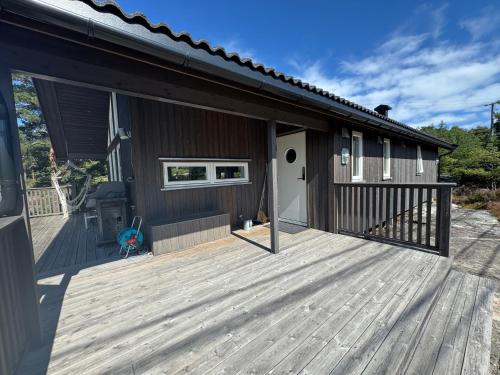 a house with a wooden deck next to a building at Sunny Side in Hvaler