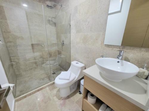 a bathroom with a toilet and a sink and a shower at Live Playa Beach, Luxury & 5th Av at your doorstep in Playa del Carmen