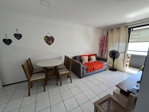 a living room with a couch and a table at Apartamento vista mar no mucuripe in Fortaleza
