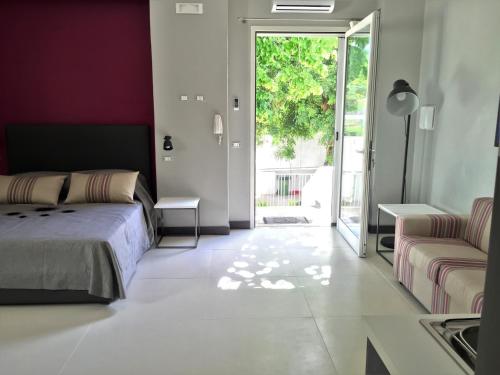 a bedroom with a bed and a sliding glass door at Le Case di Ada in Santa Cesarea Terme