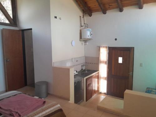 a kitchen with a sink and a counter top at Cabaña en Jardines Santa Oliva in Ciudad Lujan de Cuyo