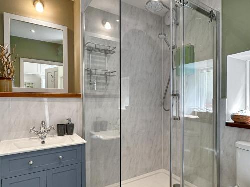 a bathroom with a shower and a sink at The Gables in Gorran Haven