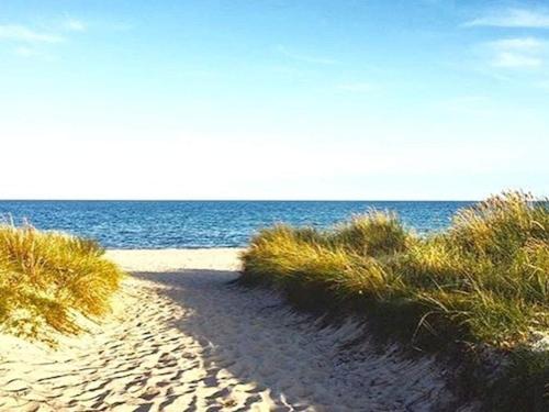 a sandy beach with the ocean in the background at Modern Oasis in Marielyst - By Traum Ferienwohnungen in Marielyst