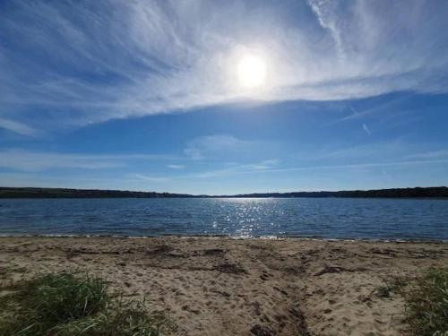 a body of water with the sun in the sky at 5 person holiday home on a holiday park in Lemvig in Lemvig