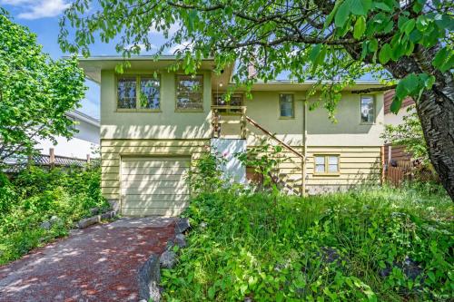 a house with a garage and a tree at Cozy Airb&b Guest Suite Near Metrotown in Burnaby