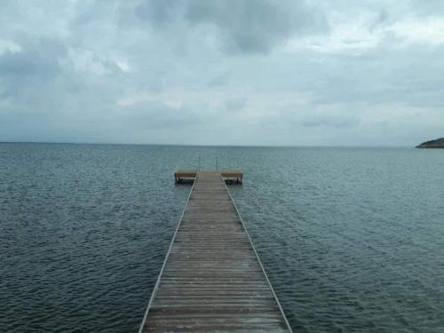 a wooden pier in the middle of the water at 5 person holiday home on a holiday park in Lemvig in Lemvig