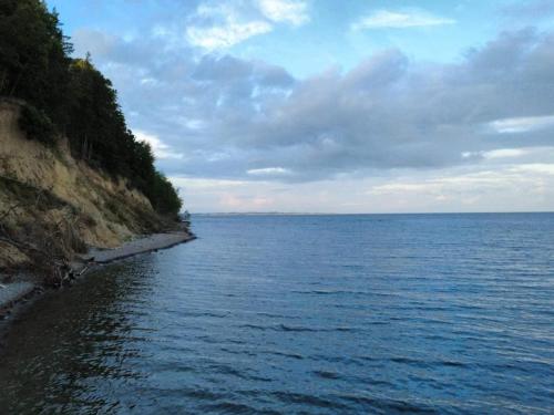 a large body of water next to a rocky shore at Luxury Seaside Retreat - By Traum Ferienwohnungen in Haderslev