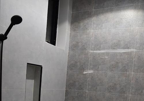 a bathroom with a shower with a mirror at شقه فرح Farah Apartment in Hail