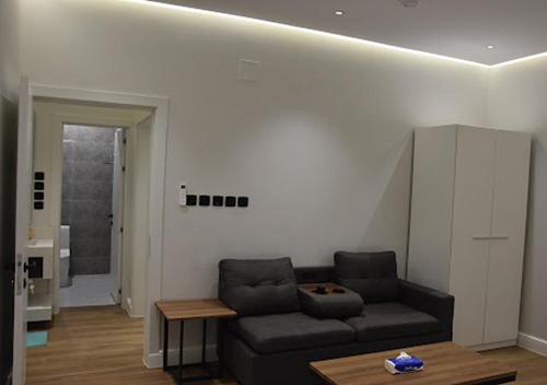 a living room with a couch and a table at شقه فرح Farah Apartment in Hail