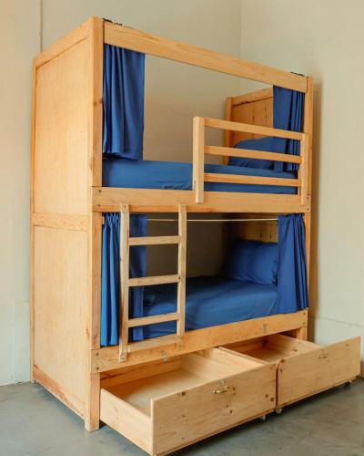 a bunk bed in a room with blue bunk beds at El Pinche Hostal in Guadalajara