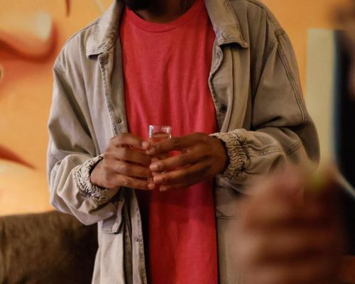 a man holding a cell phone in his hands at El Pinche Hostal in Guadalajara