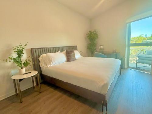 a bedroom with a bed and a large window at Designer 1 Bedroom Condo in Silver Lake in Los Angeles