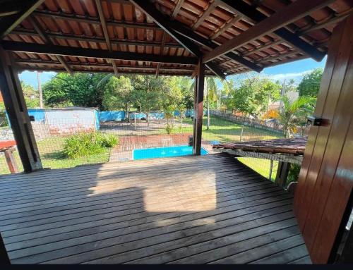 a wooden deck with a view of a yard at Casa Tropical in Marau
