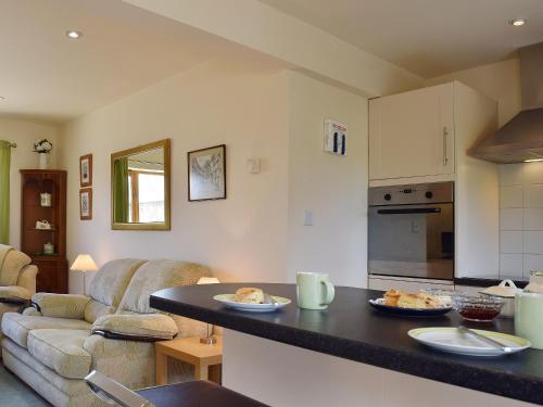 a kitchen with a table with two plates of food on it at Sunrise in Coughton