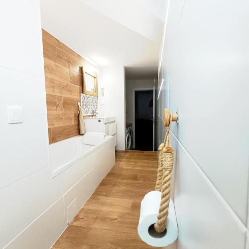 a white hallway with a white wall and a floor at SUPERTUBOS HOUSE Peniche in Peniche