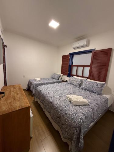 Ένα ή περισσότερα κρεβάτια σε δωμάτιο στο Pousada Casa Cota