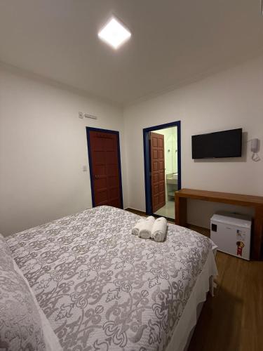 Ένα ή περισσότερα κρεβάτια σε δωμάτιο στο Pousada Casa Cota