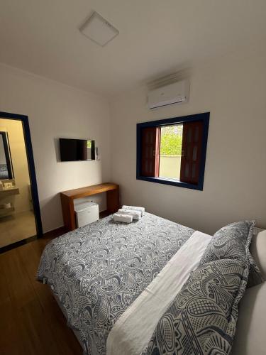 Ένα ή περισσότερα κρεβάτια σε δωμάτιο στο Pousada Casa Cota