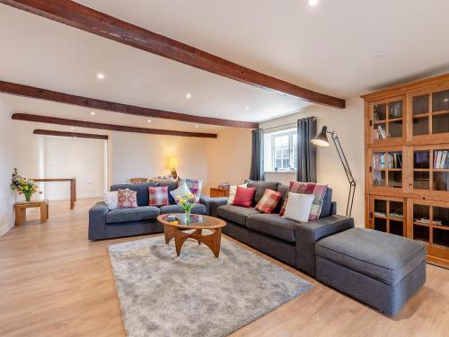 a living room with two couches and a table at Oast View - Uk43088 in Preston