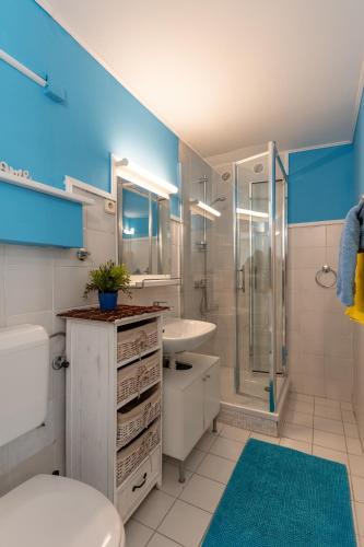 a bathroom with a toilet sink and a shower at Apartments with parking space Vidalici, Pag - 9393 in Kustići